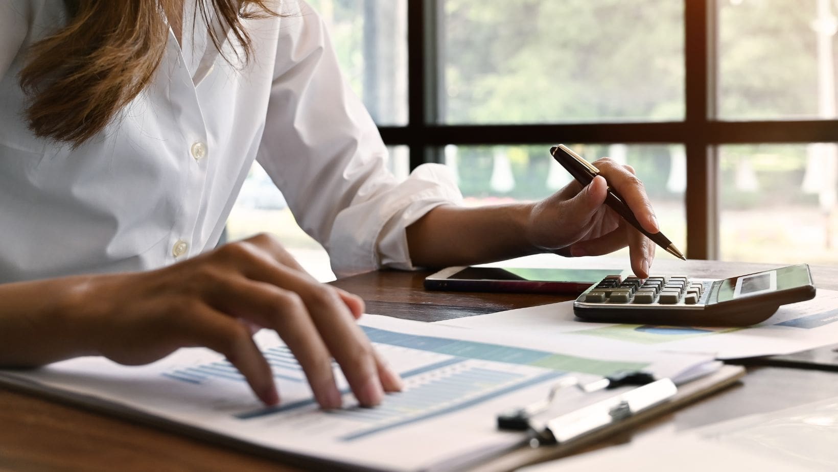 An employee reviewing home insurance paperwork, assisting homeowners with roof damage claims and repair estimates. Empire Contractors LLC provides expert roofing services and insurance claim assistance in Cincinnati, OH, and surrounding areas.
