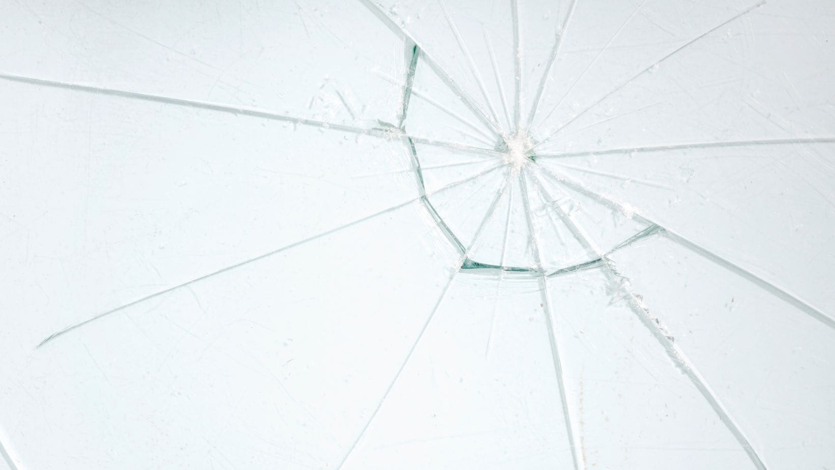 Close-up of a cracked residential window, highlighting the need for repair or replacement. Empire Contractors LLC provides professional window repair and installation services in Cincinnati, OH, and surrounding areas.